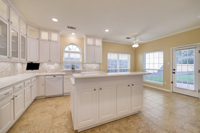 5022 Coral Gables Dr, Houston, TX 77069 - kitchen featuring dishwasher, ornamental molding, a center island, plenty of natural light, and tasteful backsplash