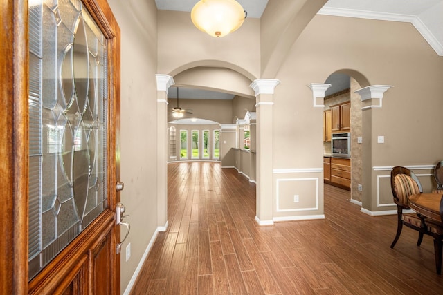 31406 Spica St, Tomball, TX 77375 - foyer with ornate columns, wood finished floors, a ceiling fan, arched walkways, and a towering ceiling