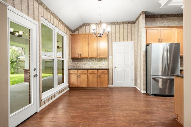 31406 Spica St, Tomball, TX 77375 - kitchen with freestanding refrigerator, a chandelier, lofted ceiling, dark countertops, and dark wood-type flooring