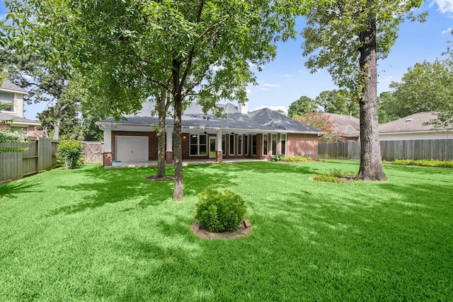 31406 Spica St, Tomball, TX 77375 - back of property with brick siding, a fenced backyard, and a garage