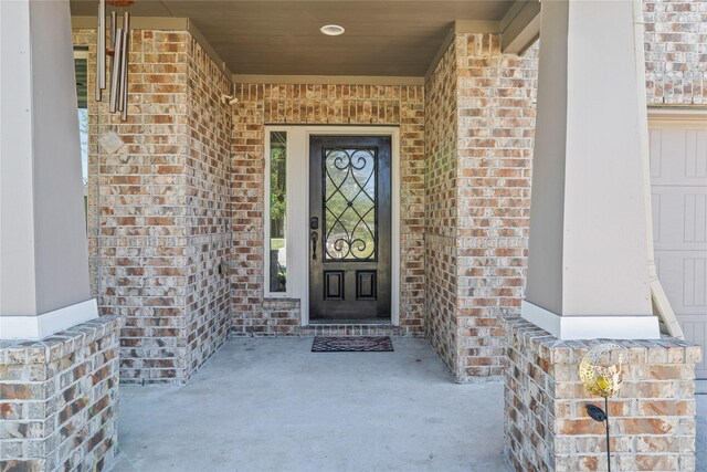 24111 Auburn Woods Ct, Porter, TX 77365 - view of exterior entry featuring brick siding and a porch