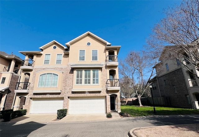 8018 Stoneyway Dr, Houston, TX 77040 - view of front of property featuring driveway, a balcony, an attached garage, and stucco siding