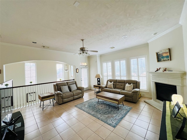8018 Stoneyway Dr, Houston, TX 77040 - living room with crown molding, ceiling fan, light tile patterned floors, a fireplace with raised hearth, and arched walkways