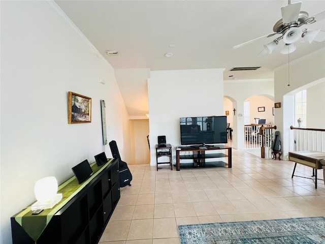 8018 Stoneyway Dr, Houston, TX 77040 - living room with light tile patterned flooring, ornamental molding, ceiling fan, and arched walkways