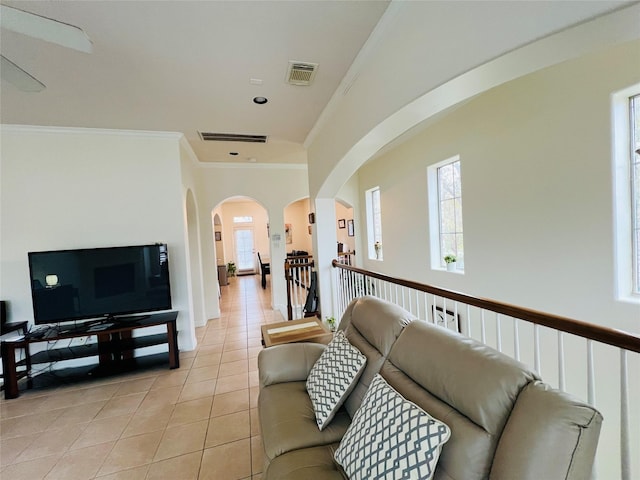 8018 Stoneyway Dr, Houston, TX 77040 - living room featuring light tile patterned floors, ornamental molding, and arched walkways