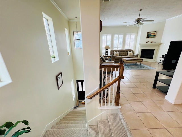 8018 Stoneyway Dr, Houston, TX 77040 - stairway featuring tile patterned floors, a fireplace, ceiling fan, and crown molding