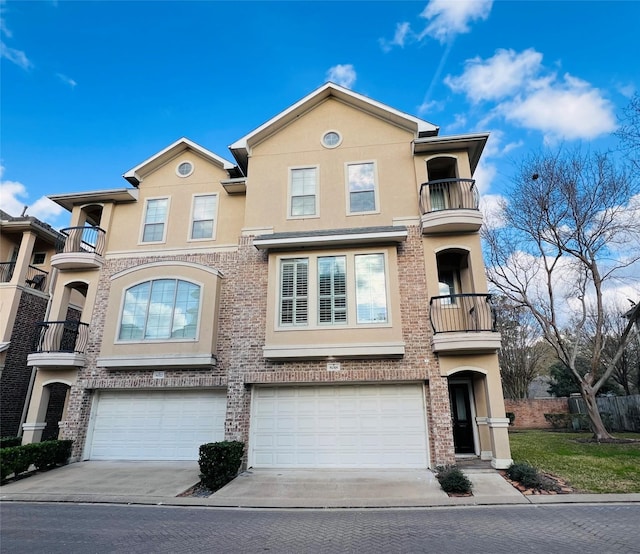 8018 Stoneyway Dr, Houston, TX 77040 - mediterranean / spanish house featuring a balcony, stucco siding, driveway, and a garage