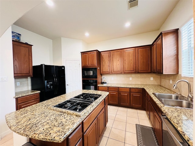 8018 Stoneyway Dr, Houston, TX 77040 - kitchen featuring black appliances, decorative backsplash, a center island, light tile patterned flooring, and arched walkways