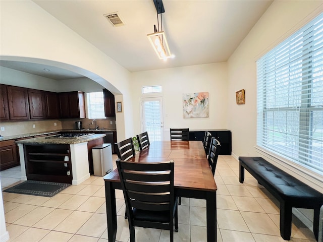 8018 Stoneyway Dr, Houston, TX 77040 - dining space featuring light tile patterned floors and arched walkways
