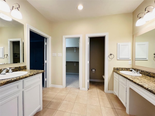 8018 Stoneyway Dr, Houston, TX 77040 - full bath with two vanities, tile patterned floors, and a walk in closet