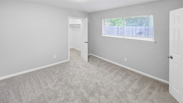 2414 Stillmeadow Dr, Missouri City, TX 77489 - unfurnished bedroom featuring carpet flooring, a walk in closet, and a closet