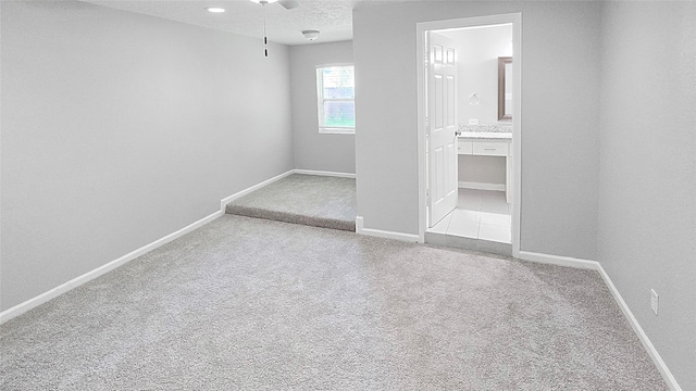2414 Stillmeadow Dr, Missouri City, TX 77489 - unfurnished bedroom with carpet floors, connected bathroom, and a textured ceiling