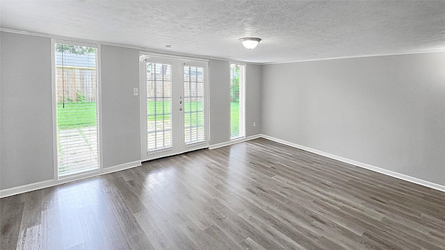 2414 Stillmeadow Dr, Missouri City, TX 77489 - empty room with dark wood-style floors, french doors, a textured ceiling, and ornamental molding