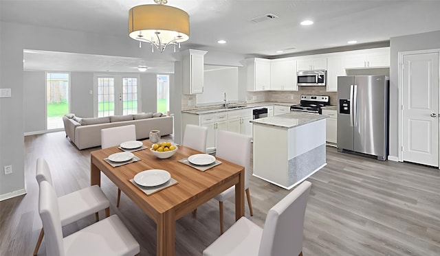 2414 Stillmeadow Dr, Missouri City, TX 77489 - dining room featuring light wood-style flooring and recessed lighting
