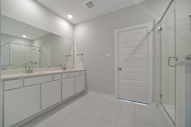 2556 Newport Breeze Dr, Katy, TX 77493 - bathroom with a shower stall, double vanity, tile patterned flooring, and recessed lighting
