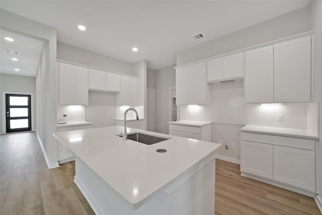 2556 Newport Breeze Dr, Katy, TX 77493 - kitchen with a center island with sink, white cabinets, light wood finished floors, and recessed lighting