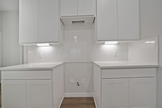 2556 Newport Breeze Dr, Katy, TX 77493 - kitchen with dark wood-style floors, backsplash, light countertops, and white cabinetry