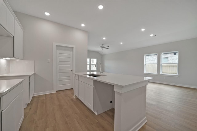 2556 Newport Breeze Dr, Katy, TX 77493 - kitchen with light wood finished floors, open floor plan, recessed lighting, and white cabinets