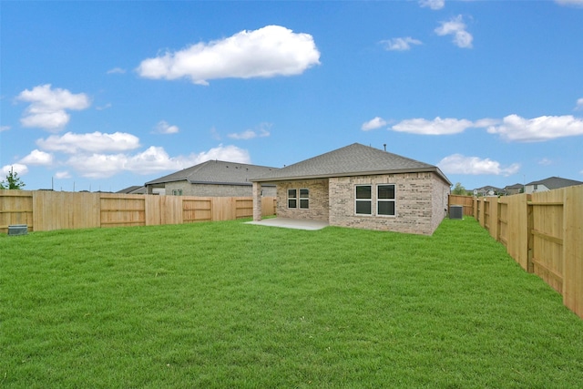2556 Newport Breeze Dr, Katy, TX 77493 - rear view of house with a fenced backyard, a patio area, a shingled roof, and brick siding