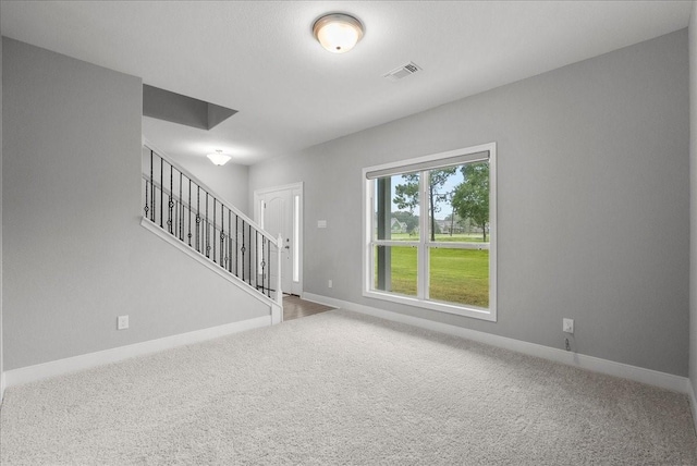 5000 Boreas Dr, Alvin, TX 77511 - unfurnished living room featuring carpet floors and stairway