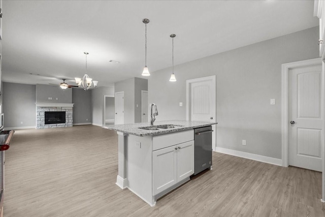 5000 Boreas Dr, Alvin, TX 77511 - kitchen featuring stainless steel dishwasher, light wood-style floors, and white cabinets