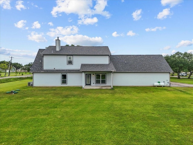 5000 Boreas Dr, Alvin, TX 77511 - back of property with a chimney, a yard, and a patio