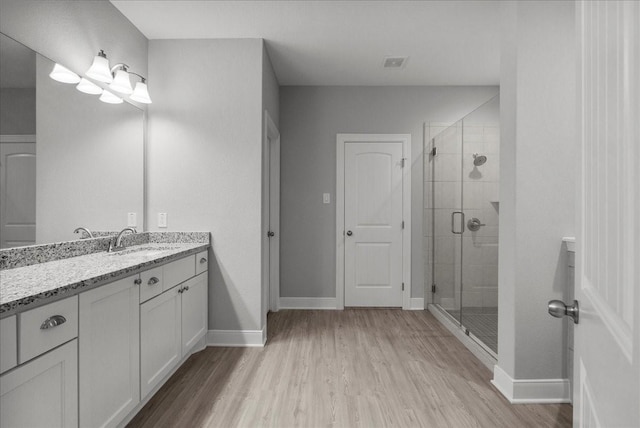 5000 Boreas Dr, Alvin, TX 77511 - bathroom with wood finished floors, vanity, and a shower stall