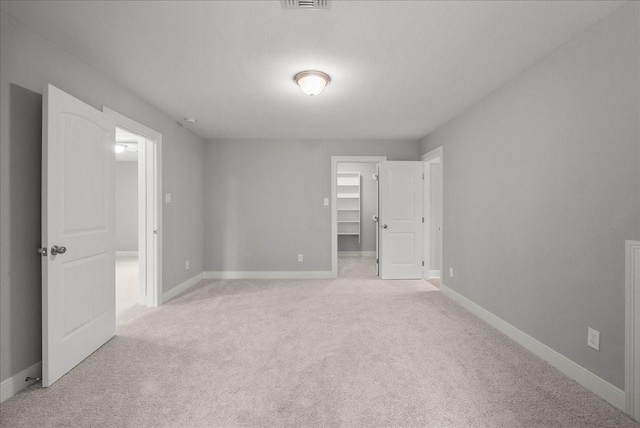 5000 Boreas Dr, Alvin, TX 77511 - unfurnished bedroom featuring light colored carpet and a walk in closet