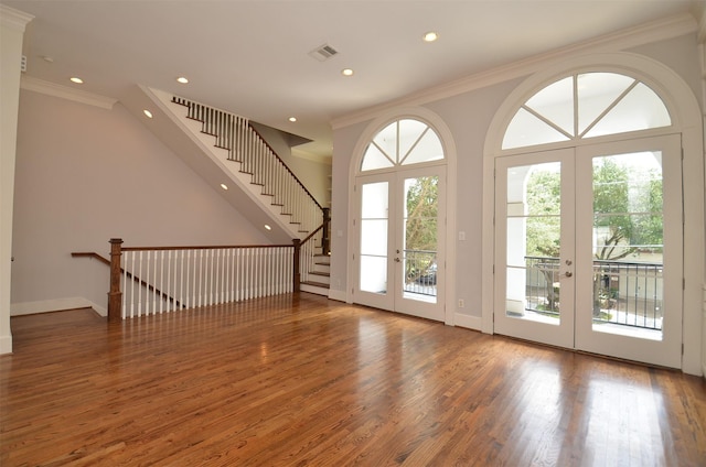 1605 Cohn St, Houston, TX 77007 - unfurnished living room featuring french doors, wood finished floors, ornamental molding, recessed lighting, and stairway
