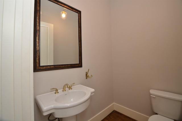 1605 Cohn St, Houston, TX 77007 - half bathroom featuring baseboards and wood finished floors