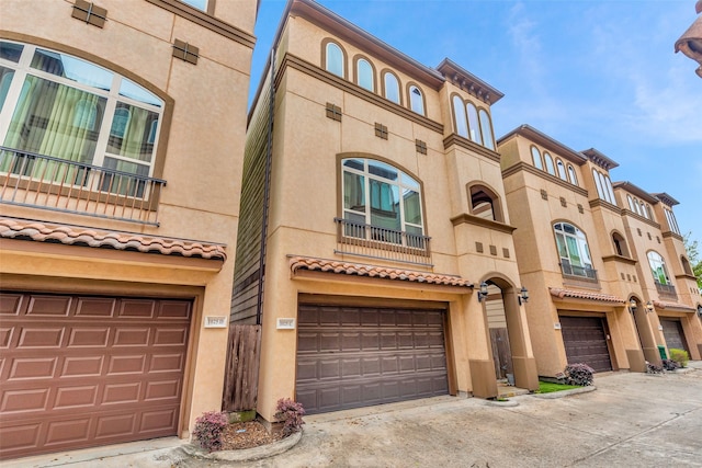 1025 W 21st St Unit C, Houston, TX 77008 - view of front of home with an attached garage, stucco siding, a balcony, and driveway