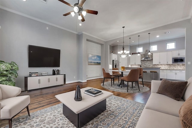 1025 W 21st St Unit C, Houston, TX 77008 - living room featuring a ceiling fan, dark wood finished floors, a chandelier, recessed lighting, and crown molding
