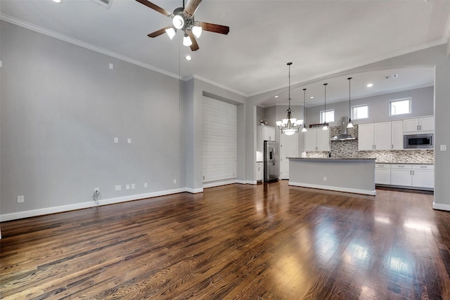 1025 W 21st St Unit C, Houston, TX 77008 - unfurnished living room featuring ceiling fan, a chandelier, dark wood finished floors, recessed lighting, and crown molding