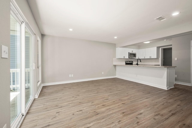 116 Harbour Ln, Coldspring, TX 77331 - unfurnished living room with wood finished floors and recessed lighting