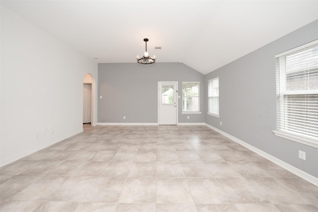 10166 Hidden Creek Falls Ln, Brookshire, TX 77423 - unfurnished room with arched walkways, a chandelier, vaulted ceiling, and light tile patterned floors