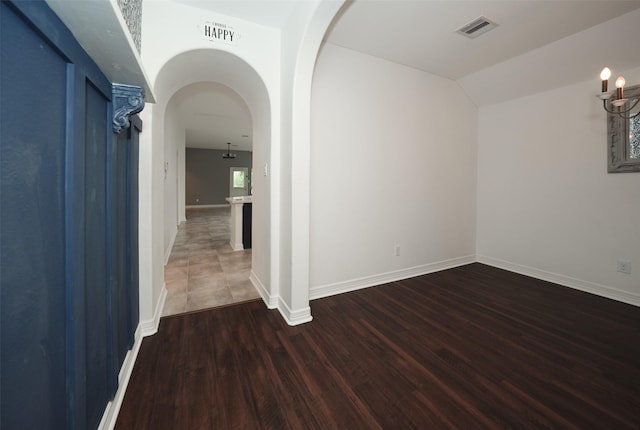10166 Hidden Creek Falls Ln, Brookshire, TX 77423 - spare room featuring arched walkways and wood finished floors