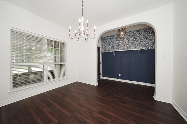 10166 Hidden Creek Falls Ln, Brookshire, TX 77423 - spare room with arched walkways, a chandelier, and dark wood-type flooring