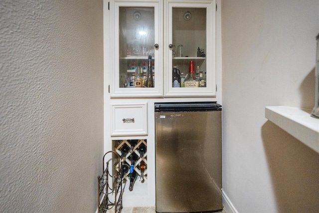 17603 Hidden Forest Dr, Spring, TX 77379 - indoor dry bar featuring refrigerator and a textured wall