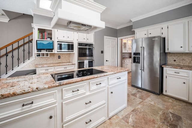 17603 Hidden Forest Dr, Spring, TX 77379 - kitchen with stainless steel appliances, backsplash, ornamental molding, white cabinets, and light stone countertops