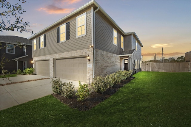 5263 Shallowhurst Ln, Katy, TX 77449 - property exterior at dusk with an attached garage, driveway, and brick siding