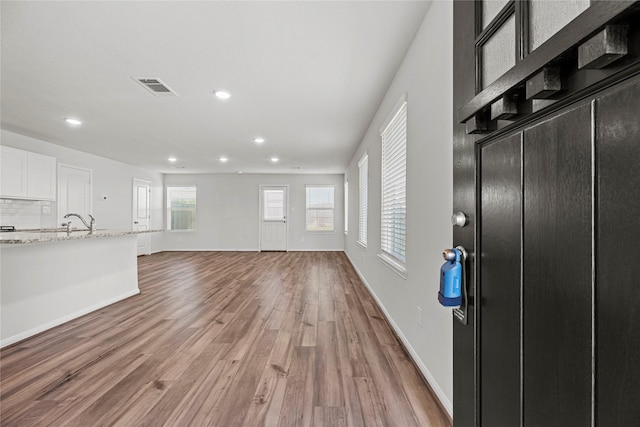 5263 Shallowhurst Ln, Katy, TX 77449 - unfurnished living room featuring light wood finished floors and recessed lighting