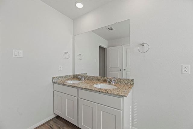 5263 Shallowhurst Ln, Katy, TX 77449 - bathroom featuring double vanity and wood finished floors