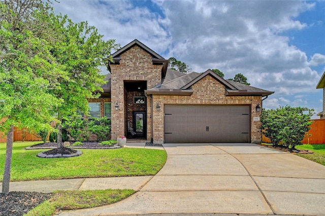 3854 Fleetwood Falls Ln, Spring, TX 77386 - traditional-style house with brick siding, an attached garage, driveway, and roof with shingles