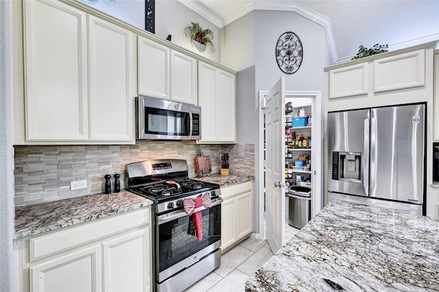 3854 Fleetwood Falls Ln, Spring, TX 77386 - kitchen with appliances with stainless steel finishes, ornamental molding, tasteful backsplash, light stone counters, and light tile patterned floors