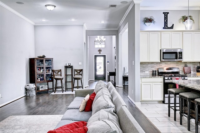 3854 Fleetwood Falls Ln, Spring, TX 77386 - living room featuring a chandelier, ornamental molding, light wood-type flooring, and recessed lighting