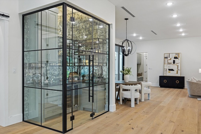 431 W 30th St, Houston, TX 77018 - wine area with wood finished floors, a chandelier, and recessed lighting