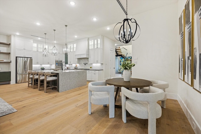 431 W 30th St, Houston, TX 77018 - dining space with a chandelier, light wood-style floors, and recessed lighting