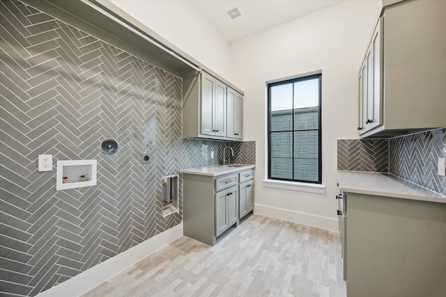 431 W 30th St, Houston, TX 77018 - washroom featuring cabinet space, hookup for an electric dryer, hookup for a washing machine, and light wood-style flooring