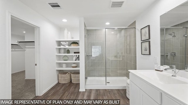 11123 Williams Reserve Dr, Conroe, TX 77303 - full bath featuring vanity, a spacious closet, a stall shower, wood finished floors, and recessed lighting