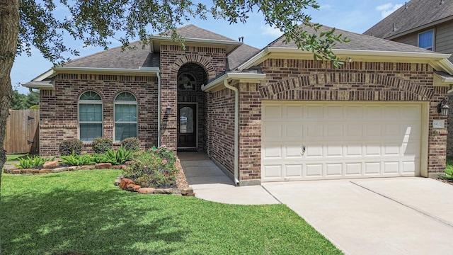 19022 Summer Farm Trl, Richmond, TX 77407 - view of front of house featuring brick siding, an attached garage, a shingled roof, and concrete driveway